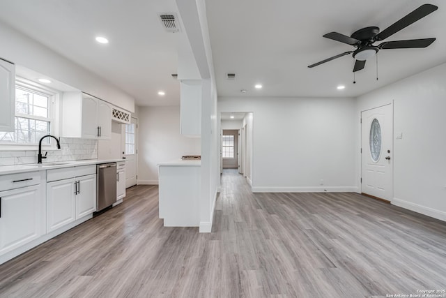 kitchen featuring white cabinetry, sink, light hardwood / wood-style floors, and ceiling fan