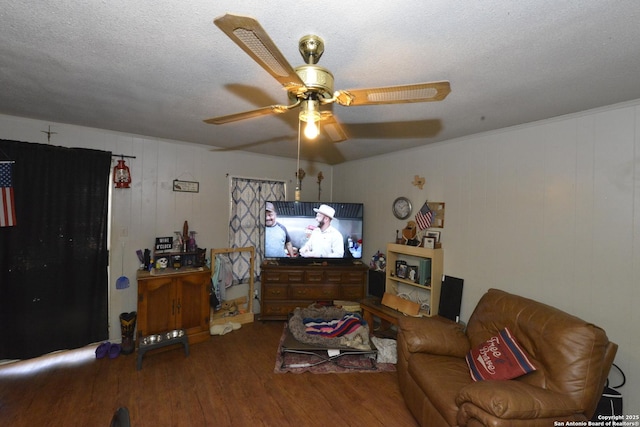 living room with ceiling fan, hardwood / wood-style floors, and a textured ceiling