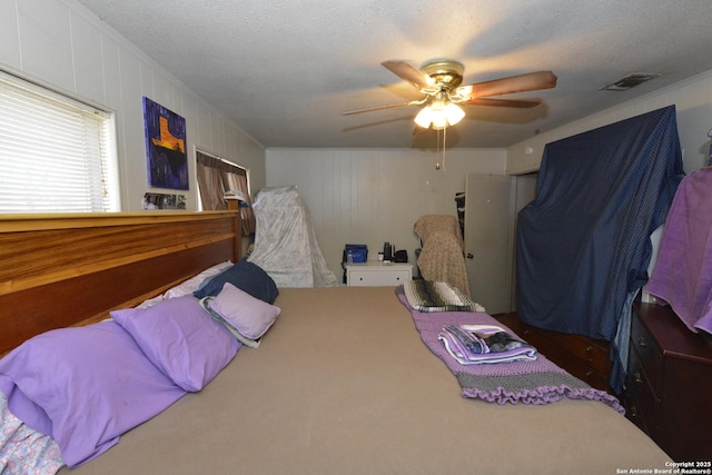 bedroom with carpet flooring, ceiling fan, and a textured ceiling