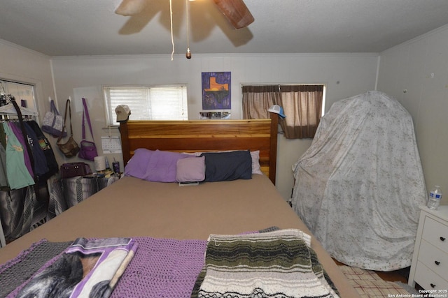 bedroom featuring ceiling fan and ornamental molding