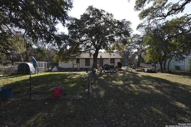 view of front of home with an outbuilding and a front lawn