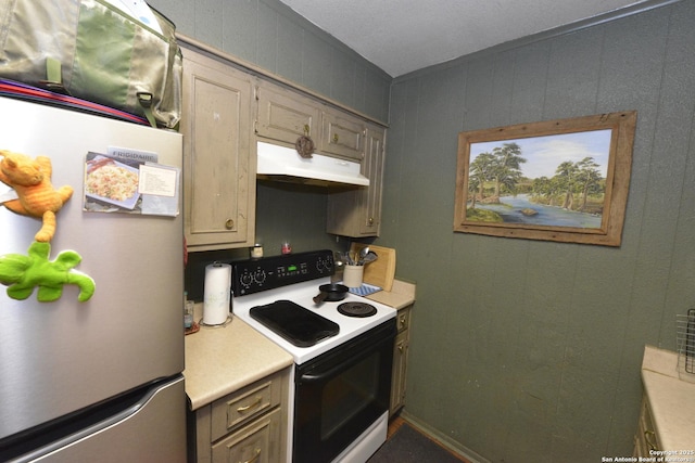 kitchen featuring white electric range, light brown cabinetry, and stainless steel refrigerator