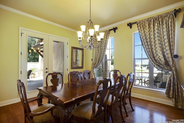 dining room with french doors, dark wood-type flooring, an inviting chandelier, and crown molding