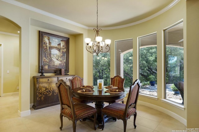 tiled dining room with an inviting chandelier and crown molding