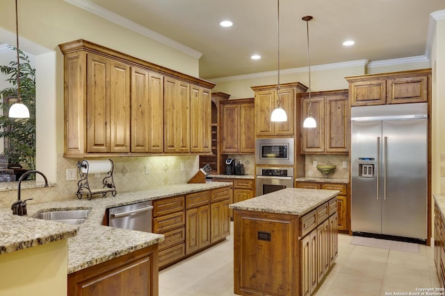 kitchen with sink, a center island, built in appliances, decorative light fixtures, and decorative backsplash