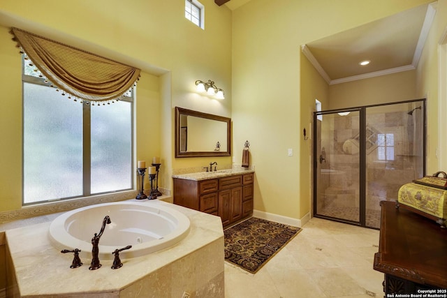 bathroom with plenty of natural light, independent shower and bath, crown molding, and vanity