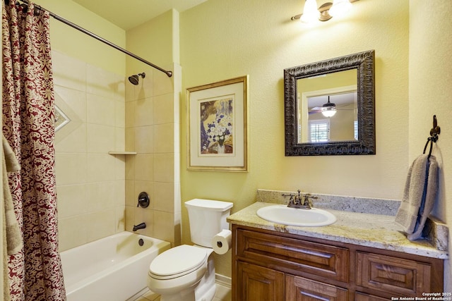 full bathroom with ceiling fan, shower / tub combo with curtain, vanity, and toilet