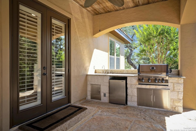 view of patio with area for grilling and sink