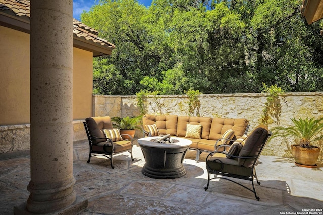 view of patio featuring an outdoor living space with a fire pit