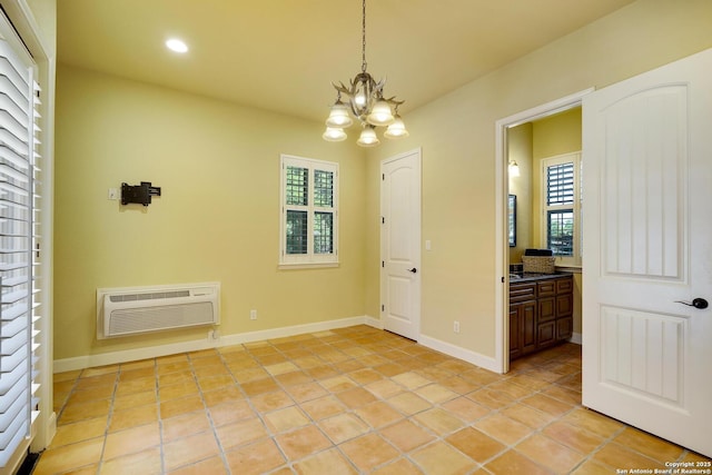 unfurnished dining area with an AC wall unit, light tile patterned floors, and an inviting chandelier