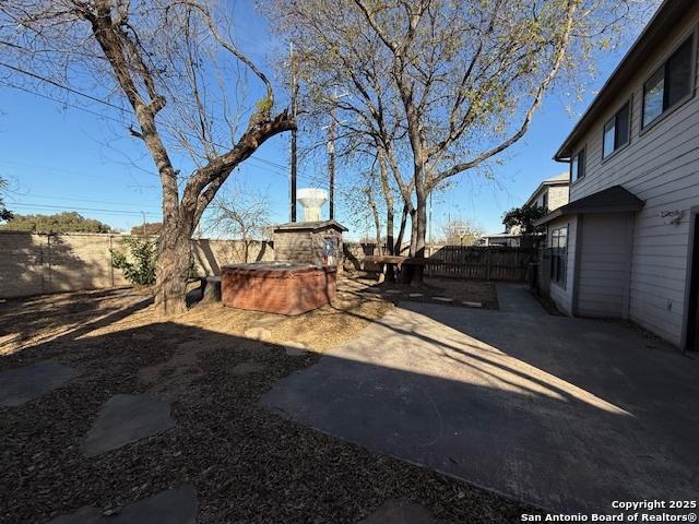 view of yard featuring a jacuzzi and a patio