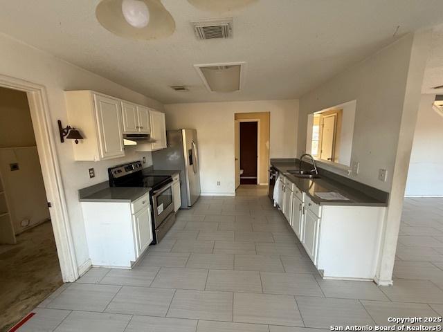 kitchen featuring white cabinetry, sink, and stainless steel appliances