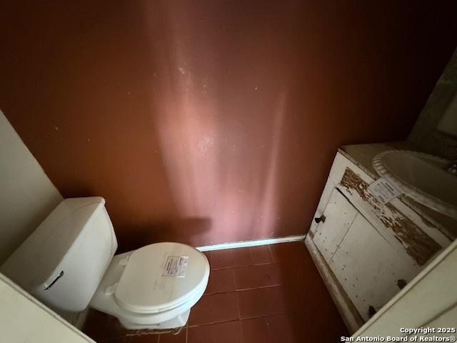 bathroom with tile patterned flooring, vanity, and toilet