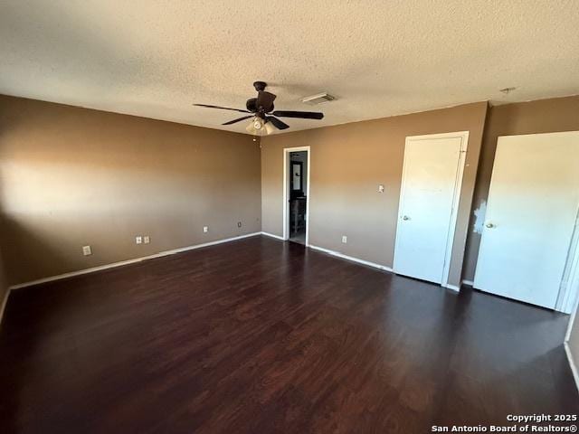 unfurnished room featuring ceiling fan, a textured ceiling, and dark wood-type flooring