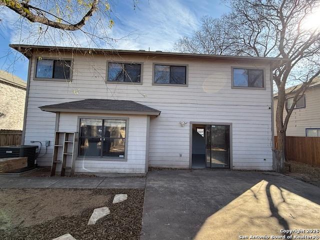 rear view of property featuring central AC unit and a patio area