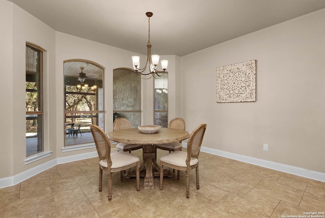 dining room with ceiling fan with notable chandelier