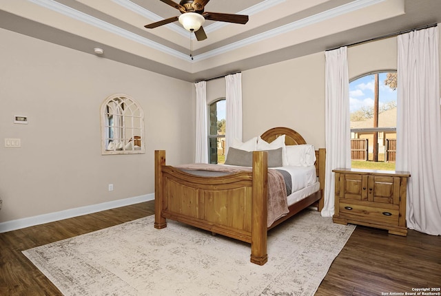 bedroom featuring a raised ceiling, ceiling fan, and dark hardwood / wood-style floors