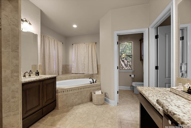 bathroom with tile patterned floors, vanity, tiled bath, and toilet