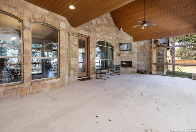 view of patio / terrace with ceiling fan and a fireplace