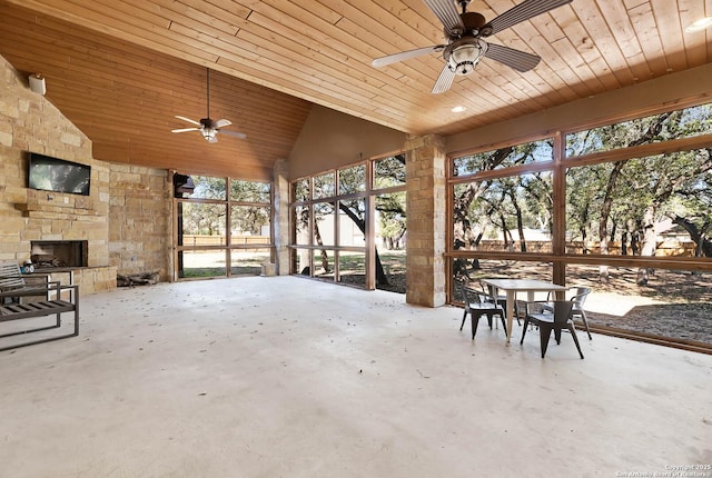 view of patio featuring ceiling fan and a fireplace