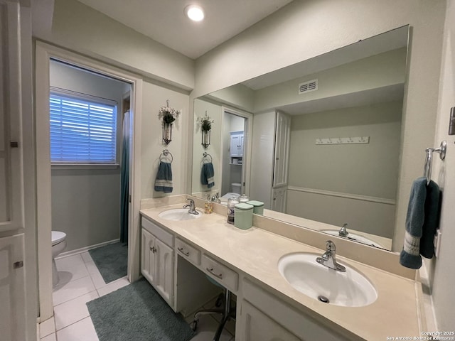 bathroom featuring tile patterned floors, toilet, and vanity