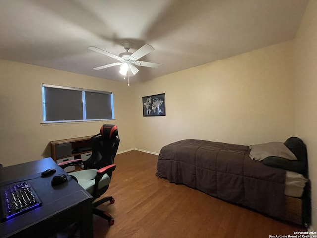 bedroom with ceiling fan and hardwood / wood-style floors