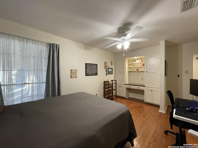 bedroom with light hardwood / wood-style flooring and ceiling fan