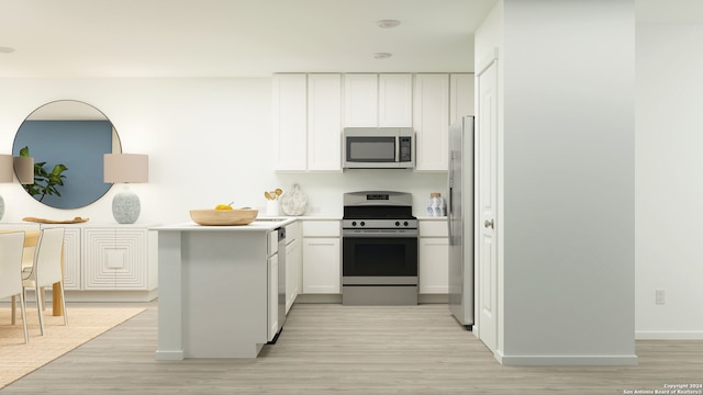 kitchen with white cabinets, stainless steel appliances, and light hardwood / wood-style flooring