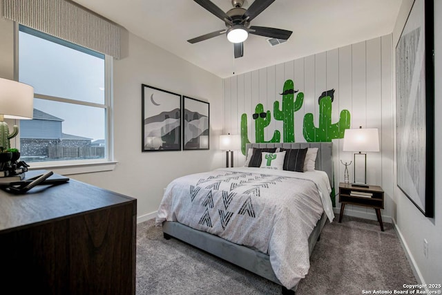 bedroom featuring ceiling fan, carpet floors, and multiple windows