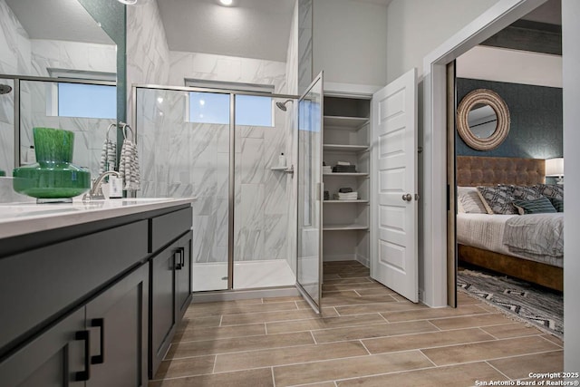 bathroom featuring vanity and a shower with door