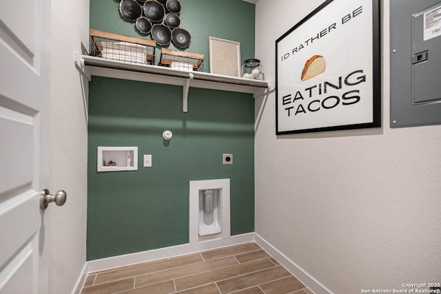 clothes washing area with electric panel, hookup for a gas dryer, hookup for a washing machine, hookup for an electric dryer, and wood-type flooring