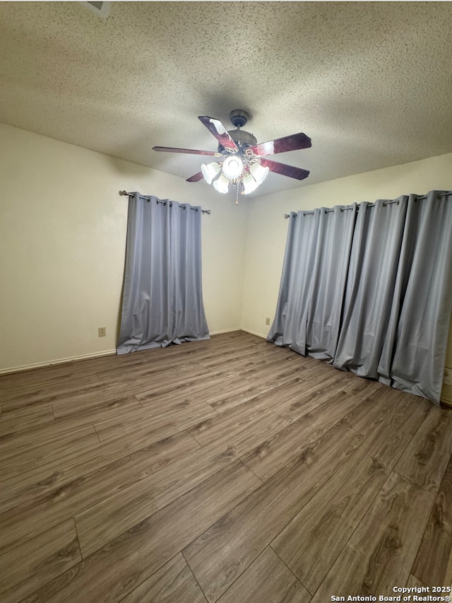 unfurnished room with hardwood / wood-style floors, a textured ceiling, and ceiling fan