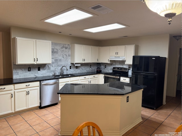 kitchen featuring stainless steel appliances, sink, light tile patterned floors, white cabinets, and a center island