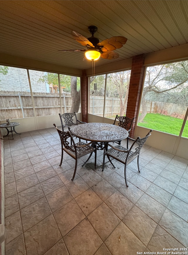 unfurnished sunroom featuring plenty of natural light and ceiling fan