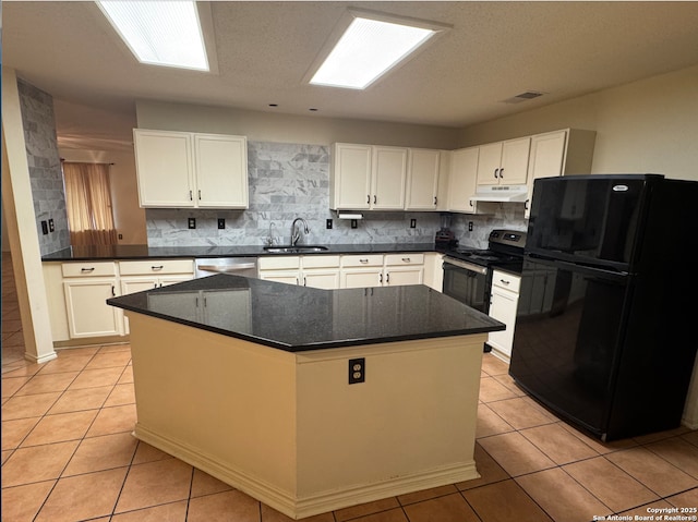 kitchen with sink, white cabinetry, stainless steel appliances, and light tile patterned floors