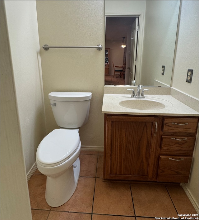 bathroom featuring tile patterned floors, vanity, and toilet