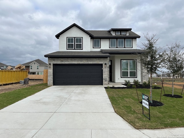 view of front of property with a garage and a front lawn