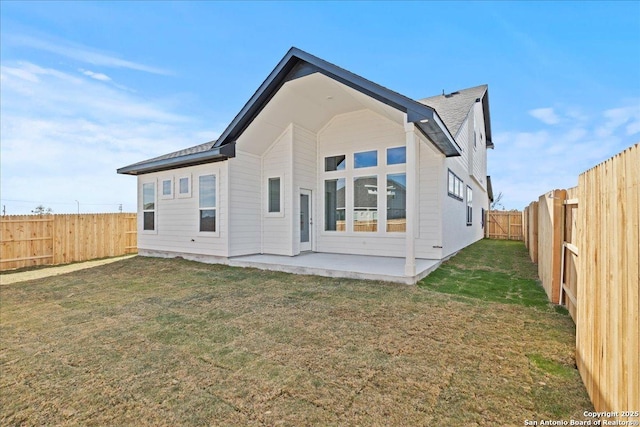 rear view of property with a lawn and a patio area