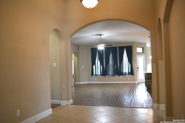 empty room featuring ceiling fan and light tile patterned flooring