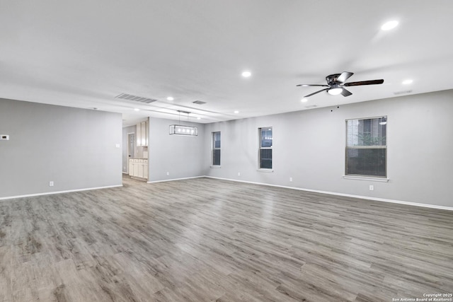 empty room with hardwood / wood-style flooring and ceiling fan