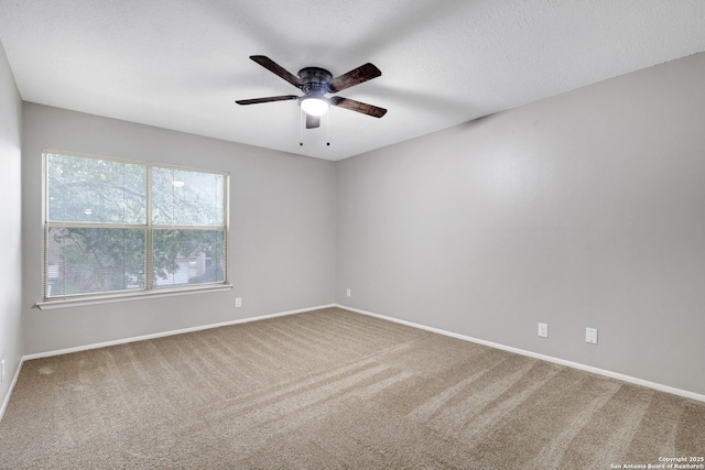 carpeted empty room with ceiling fan and a textured ceiling