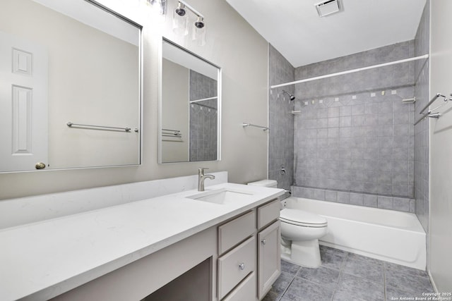 full bathroom with toilet, vanity, and tiled shower / bath