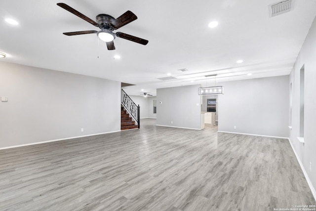 unfurnished living room featuring light wood-type flooring and ceiling fan