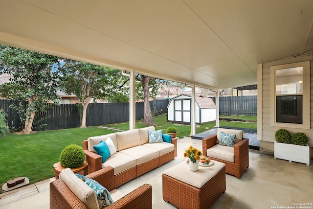 view of patio / terrace with an outdoor living space and a storage shed