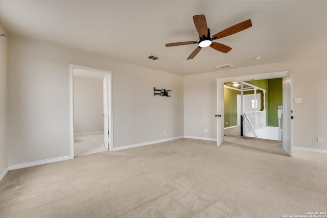 carpeted empty room featuring ceiling fan