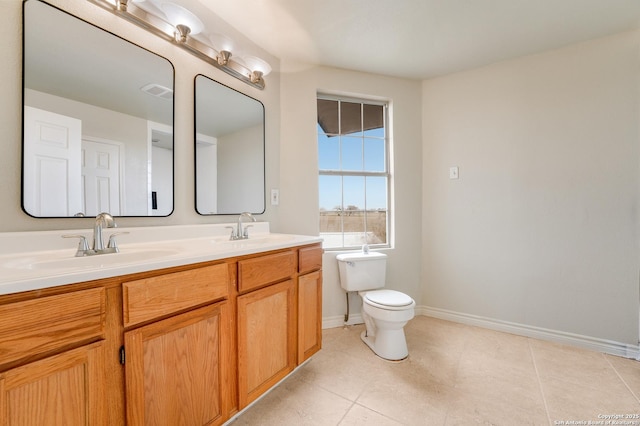 bathroom with tile patterned flooring, vanity, and toilet