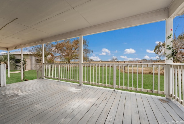 deck featuring a shed and a yard