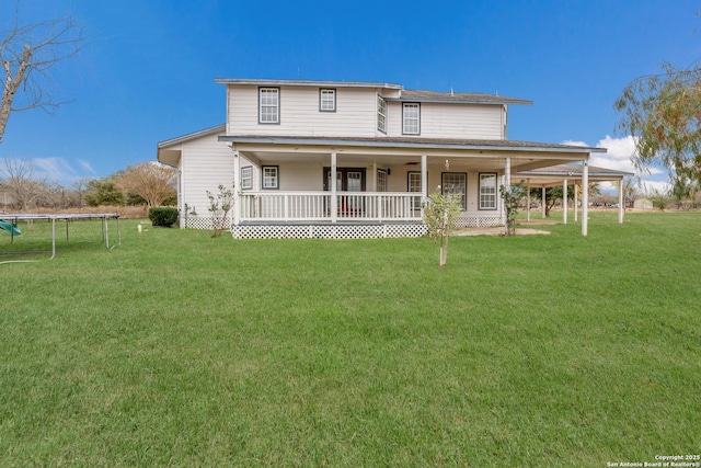 country-style home with a front yard, a trampoline, and covered porch