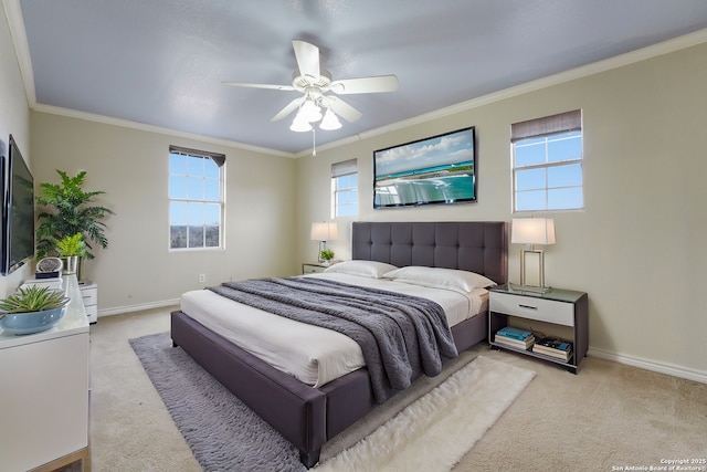 carpeted bedroom with ceiling fan and crown molding