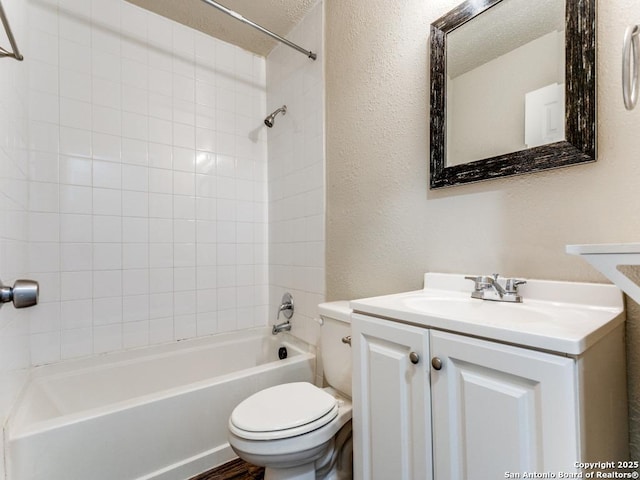 full bathroom with vanity, toilet, and tiled shower / bath combo